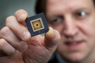 Professor Harald Haas holds a Li-Fi microchip processor